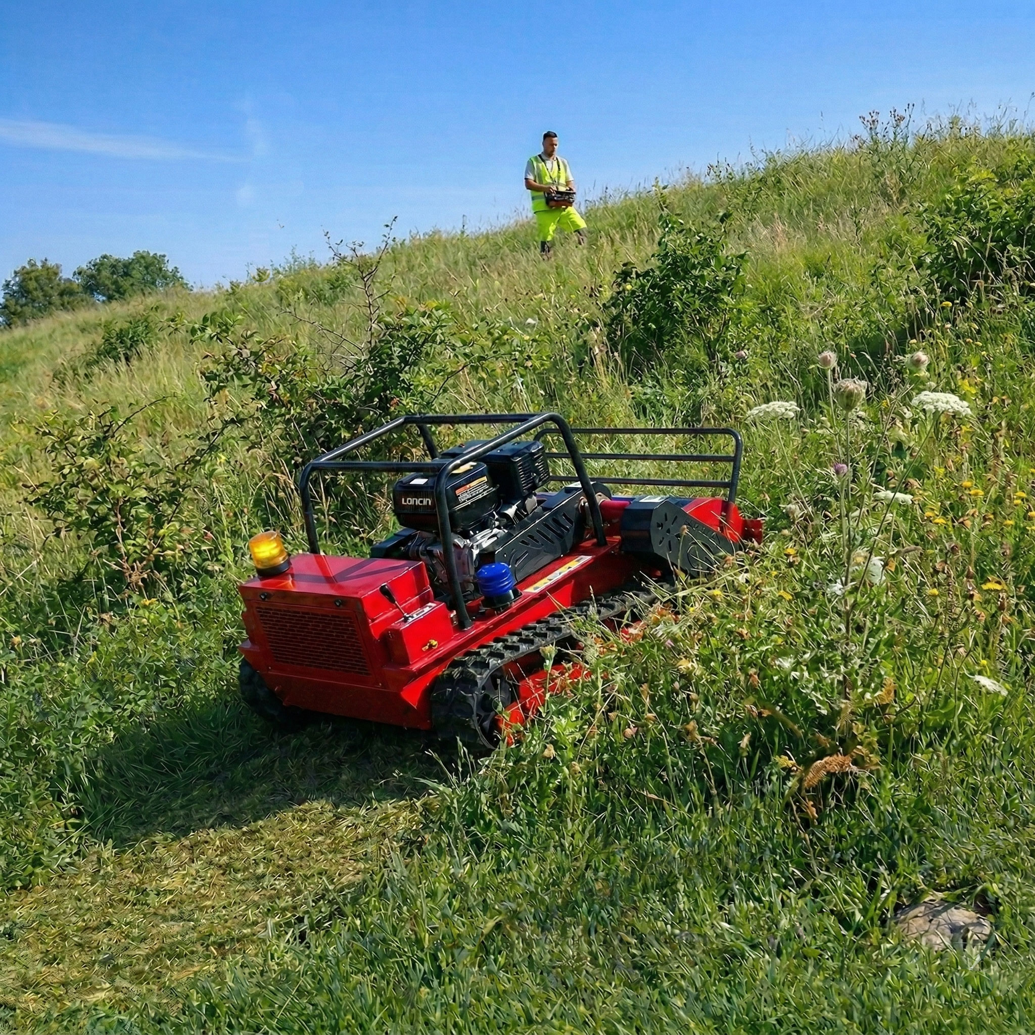 GST-1000 remote-controlled tracked flail mower working on a maintained slope